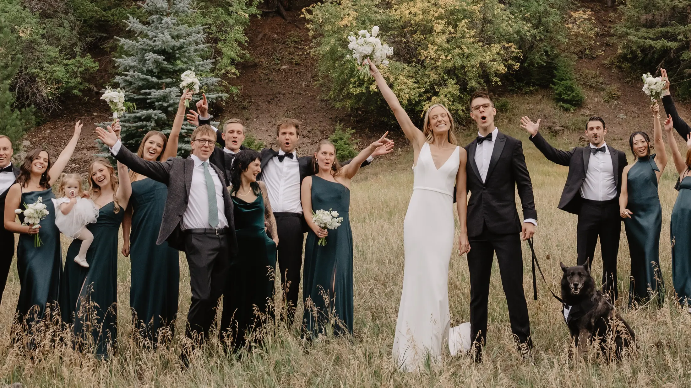 Billie and Nick celebrating with Jax and their wedding party in a mountain meadow